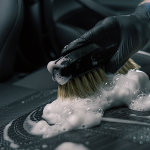 Firefly_Close-up shot of thick, rich white cleaning foam on a car seat. A professional detail 590432